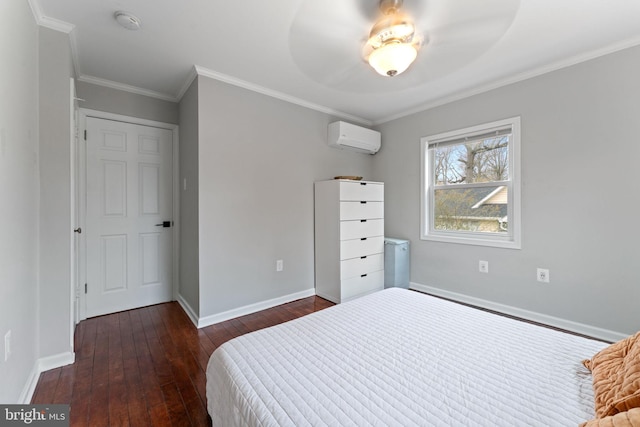 bedroom featuring ornamental molding, a wall unit AC, dark wood finished floors, and baseboards