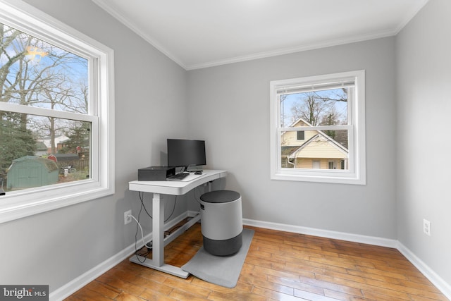 office area featuring ornamental molding, light wood-type flooring, and baseboards