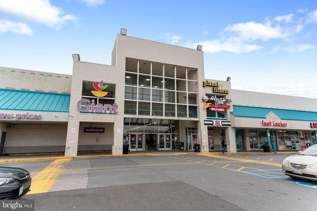 view of building exterior featuring uncovered parking