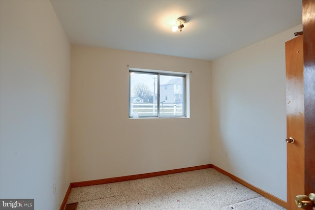 unfurnished room featuring visible vents and baseboards