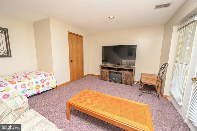 carpeted living area featuring recessed lighting, visible vents, and baseboards