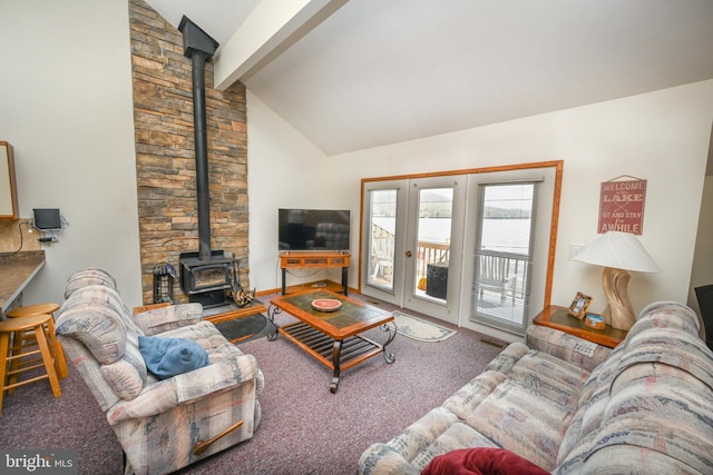 carpeted living area featuring visible vents, a wood stove, french doors, high vaulted ceiling, and beam ceiling