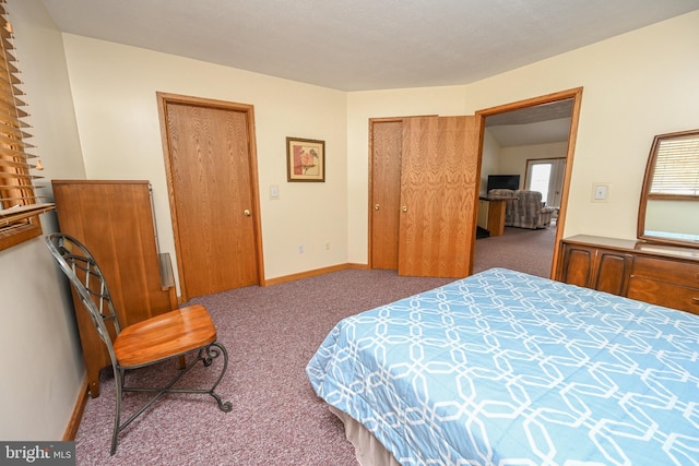 carpeted bedroom featuring baseboards