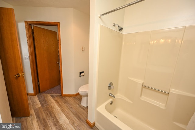 full bathroom featuring  shower combination, baseboards, toilet, and wood finished floors