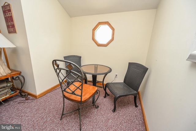 living area featuring baseboards and carpet flooring