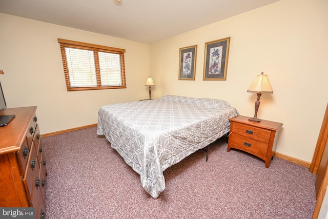 bedroom featuring carpet and baseboards