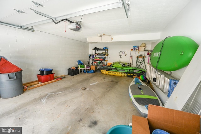 garage with concrete block wall and a garage door opener