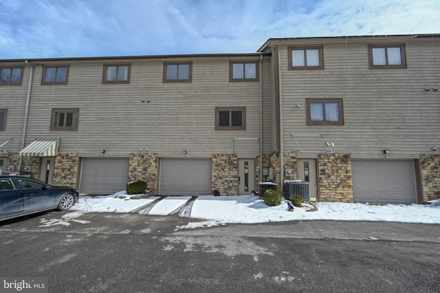 view of front of home featuring stone siding and central air condition unit