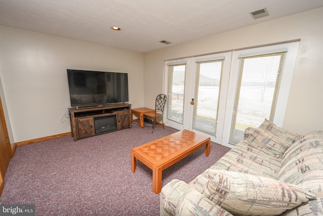 carpeted living area with baseboards, visible vents, and recessed lighting