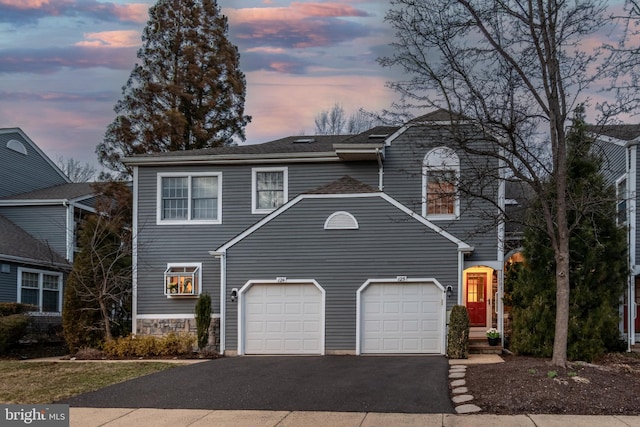 traditional-style home featuring driveway and a garage