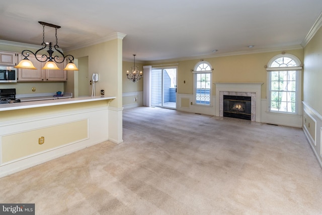 unfurnished living room with light carpet, a healthy amount of sunlight, ornamental molding, and a tile fireplace