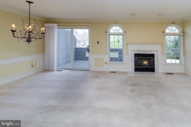 unfurnished living room featuring carpet, wainscoting, and ornamental molding