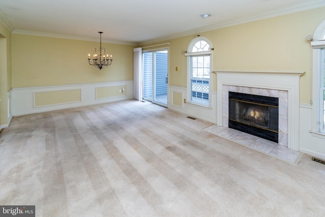 unfurnished living room featuring crown molding, a fireplace, visible vents, and carpet floors