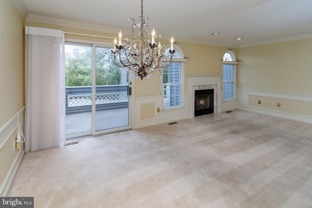 unfurnished living room featuring visible vents, ornamental molding, a high end fireplace, carpet, and wainscoting