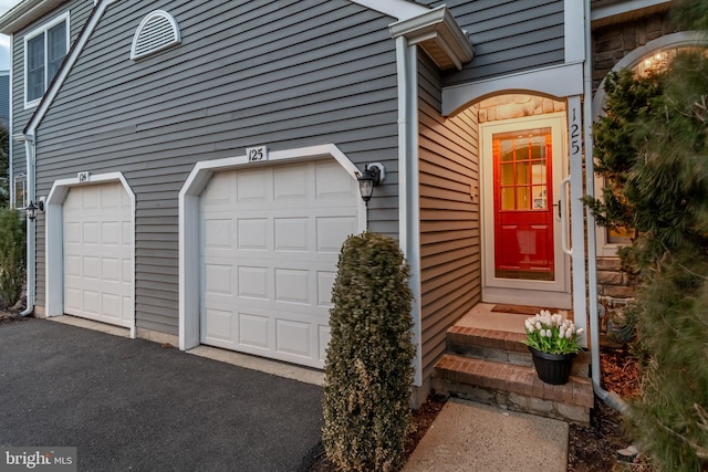 entrance to property with an attached garage