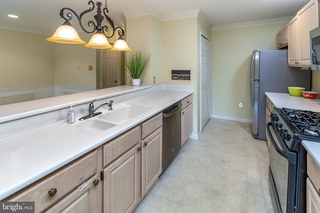 kitchen with crown molding, light countertops, appliances with stainless steel finishes, and a sink