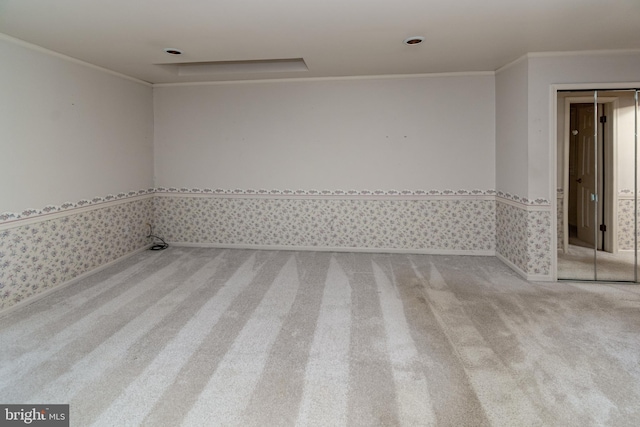 carpeted empty room with crown molding and wallpapered walls