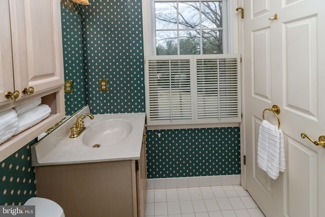 bathroom featuring tile patterned flooring, toilet, and vanity