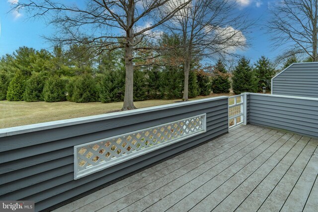 wooden deck featuring a yard