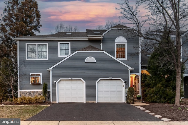 view of front of house featuring aphalt driveway and an attached garage