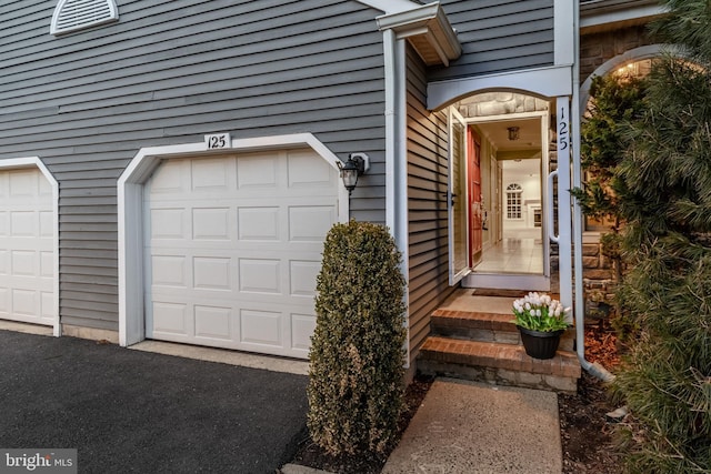 view of exterior entry with a garage