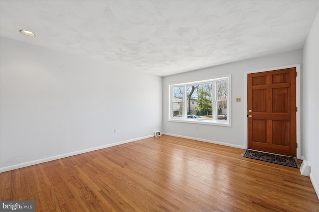 entrance foyer with recessed lighting, baseboards, visible vents, and light wood finished floors