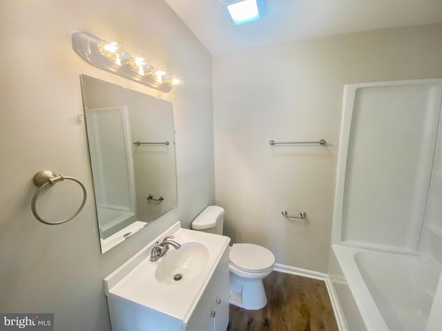 bathroom featuring toilet, wood finished floors, vanity, a shower, and a bath