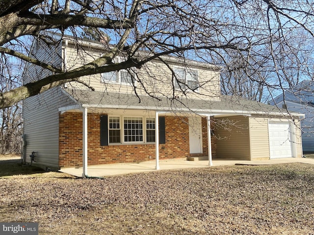 traditional-style house with a garage and brick siding