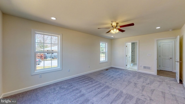 unfurnished bedroom featuring light carpet, baseboards, visible vents, ensuite bathroom, and recessed lighting