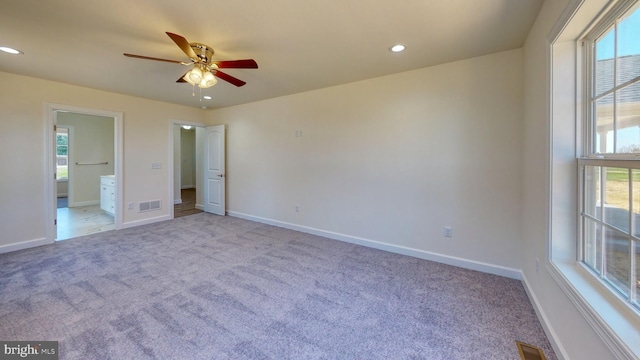 unfurnished bedroom featuring light colored carpet, visible vents, and baseboards