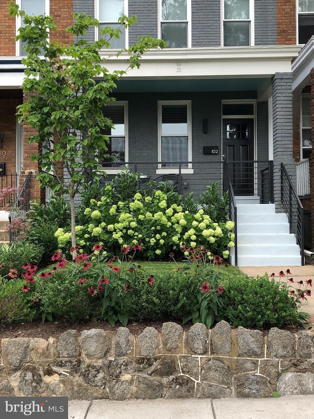 doorway to property with brick siding