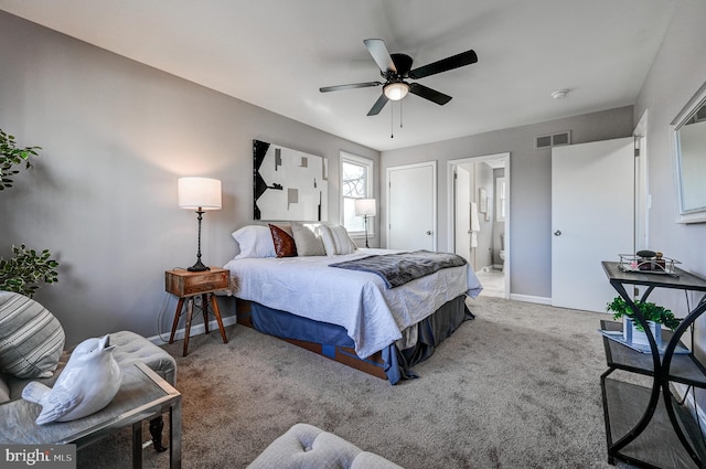 carpeted bedroom featuring visible vents, ceiling fan, baseboards, and ensuite bathroom