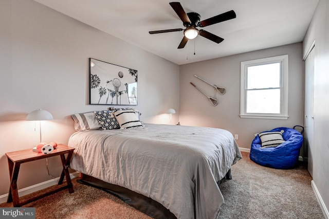 carpeted bedroom featuring ceiling fan and baseboards