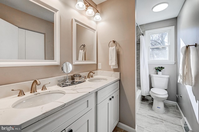 bathroom with visible vents, a sink, toilet, and double vanity