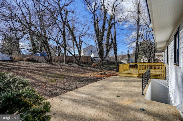 view of yard featuring fence and a deck