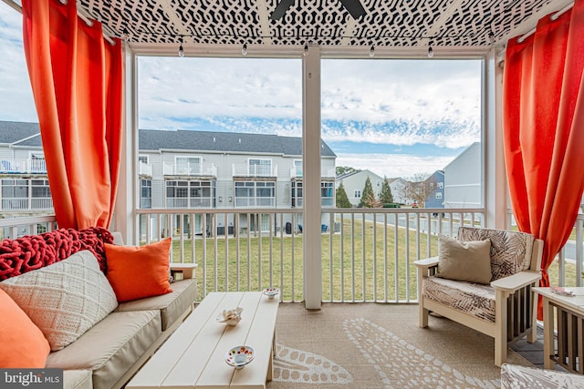 sunroom / solarium featuring a residential view