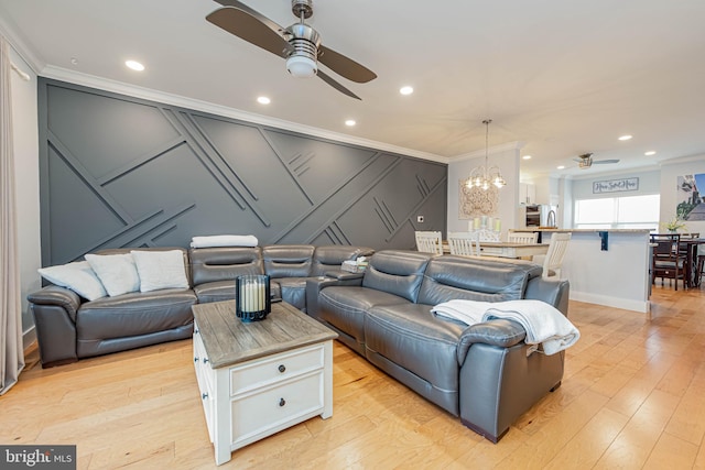 living room with recessed lighting, crown molding, light wood finished floors, and ceiling fan with notable chandelier