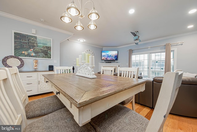 dining area featuring light wood-style floors, recessed lighting, crown molding, and an inviting chandelier