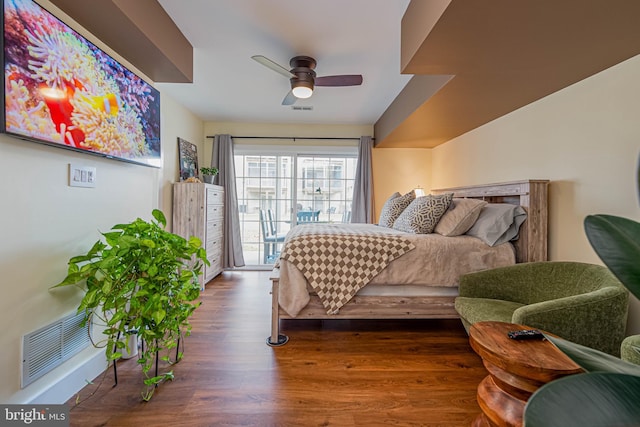 bedroom with access to exterior, a ceiling fan, visible vents, and wood finished floors