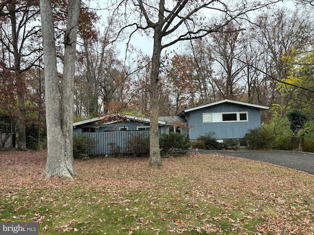 exterior space with aphalt driveway and fence