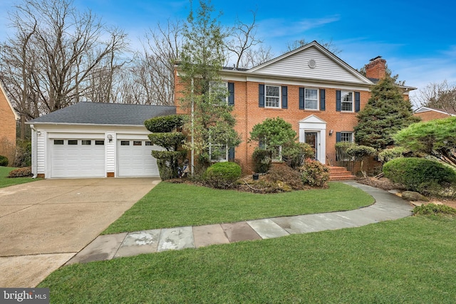 view of front facade with brick siding, a chimney, concrete driveway, an attached garage, and a front lawn