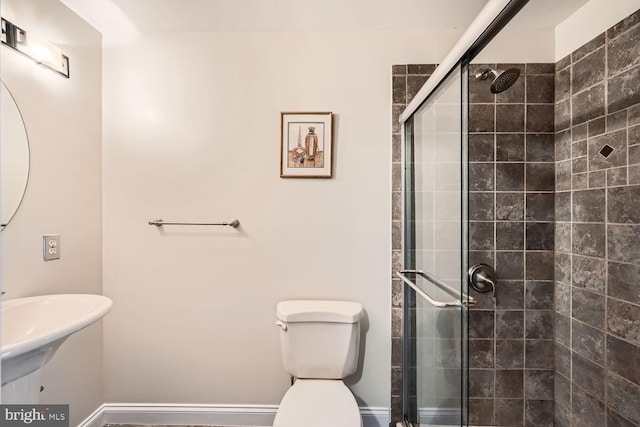 bathroom with a stall shower and toilet