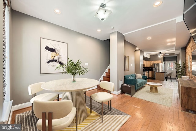 dining room with light wood-style floors, baseboards, and recessed lighting