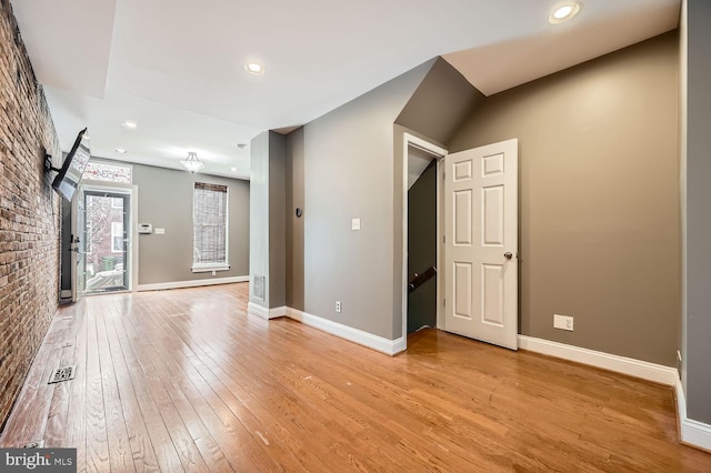 empty room with light wood-style floors, recessed lighting, visible vents, and baseboards