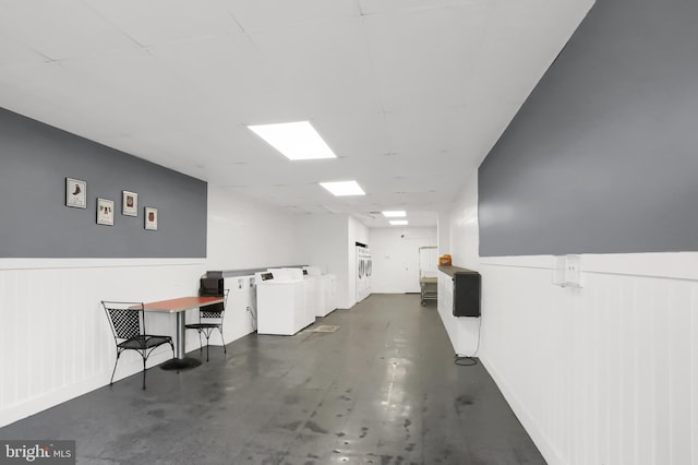 interior space featuring washing machine and clothes dryer and wainscoting