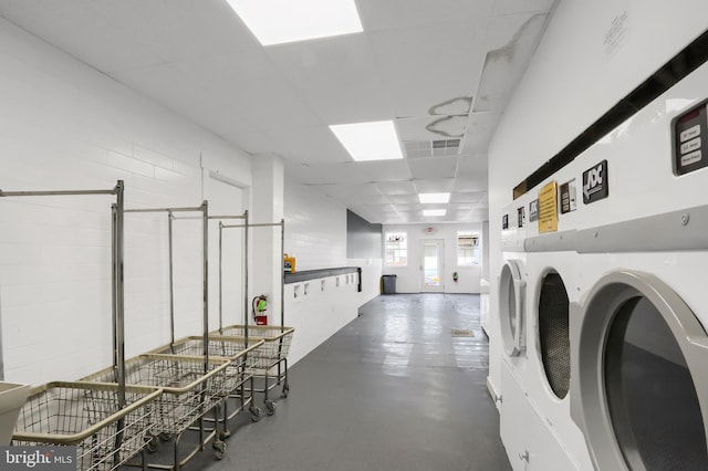 community laundry room featuring independent washer and dryer and visible vents