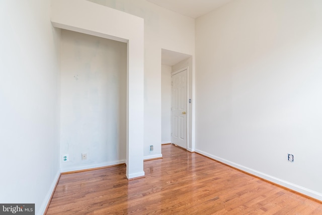 unfurnished bedroom featuring light wood-style floors and baseboards