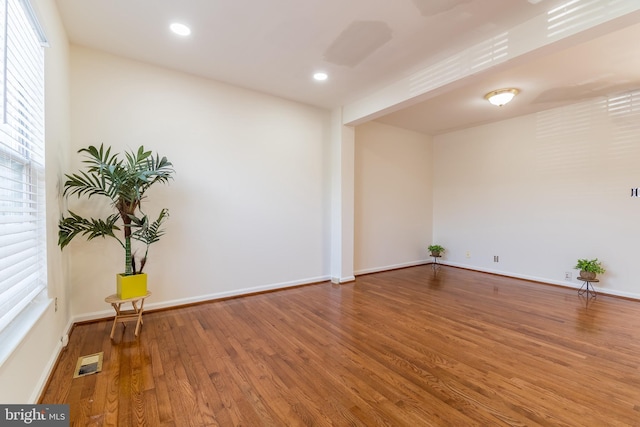 spare room with recessed lighting, visible vents, baseboards, and wood finished floors