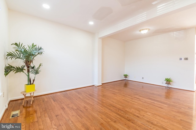 empty room with baseboards, recessed lighting, visible vents, and light wood-style floors