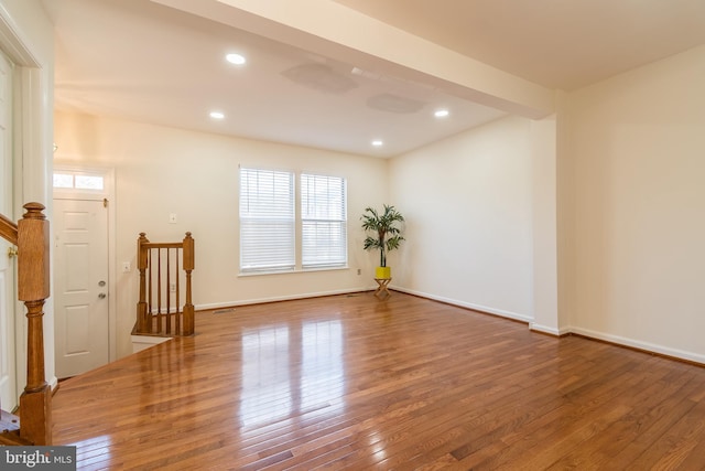 empty room featuring baseboards, wood-type flooring, and recessed lighting